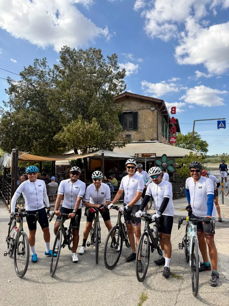 Six riders with their bikes outside a roadside bar