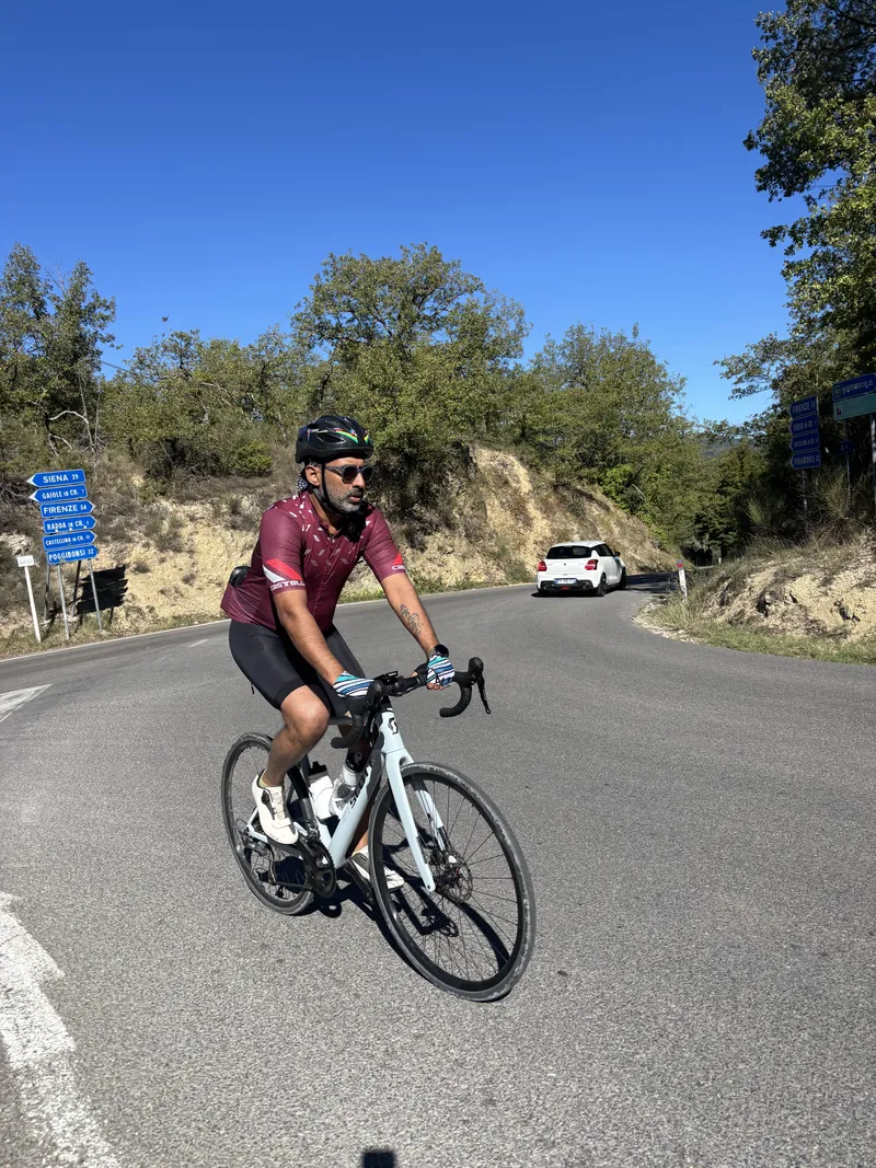 A rider leaning into a bend on a descending road