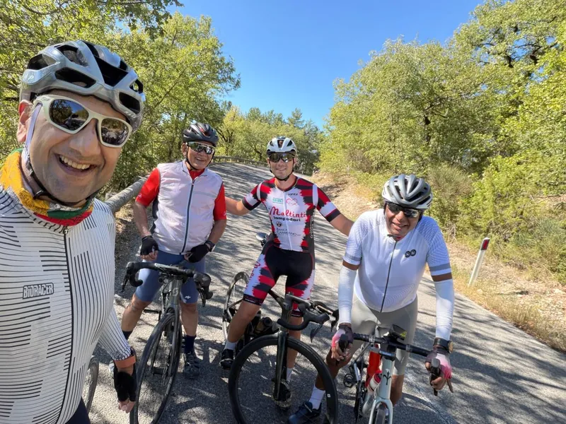Four riders take a selfie on a sunny roadside