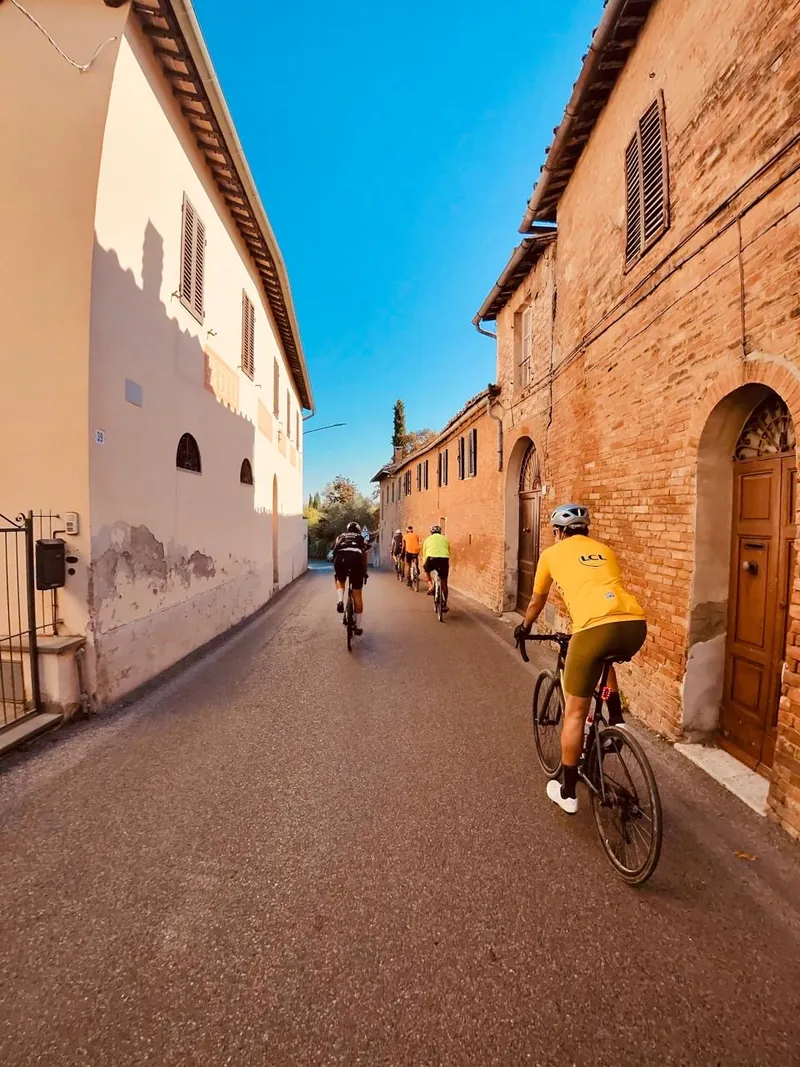 Riders passing through a street of brick houses