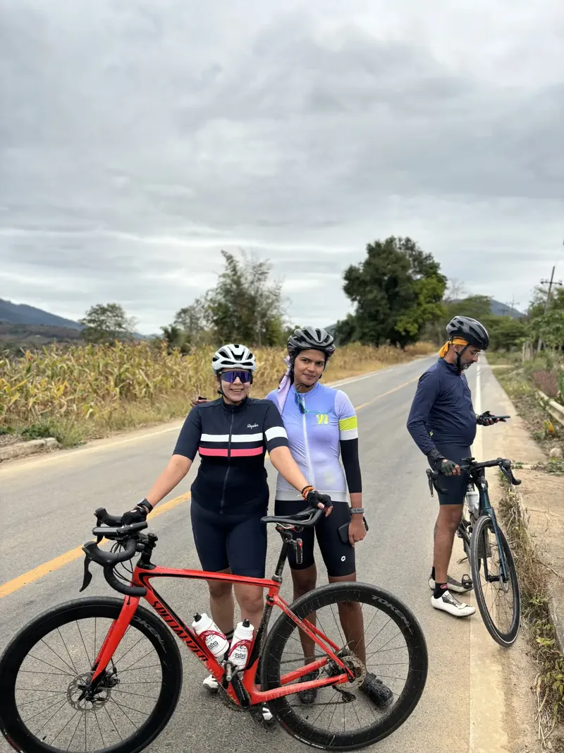 Two riders on an open road under a pale sky